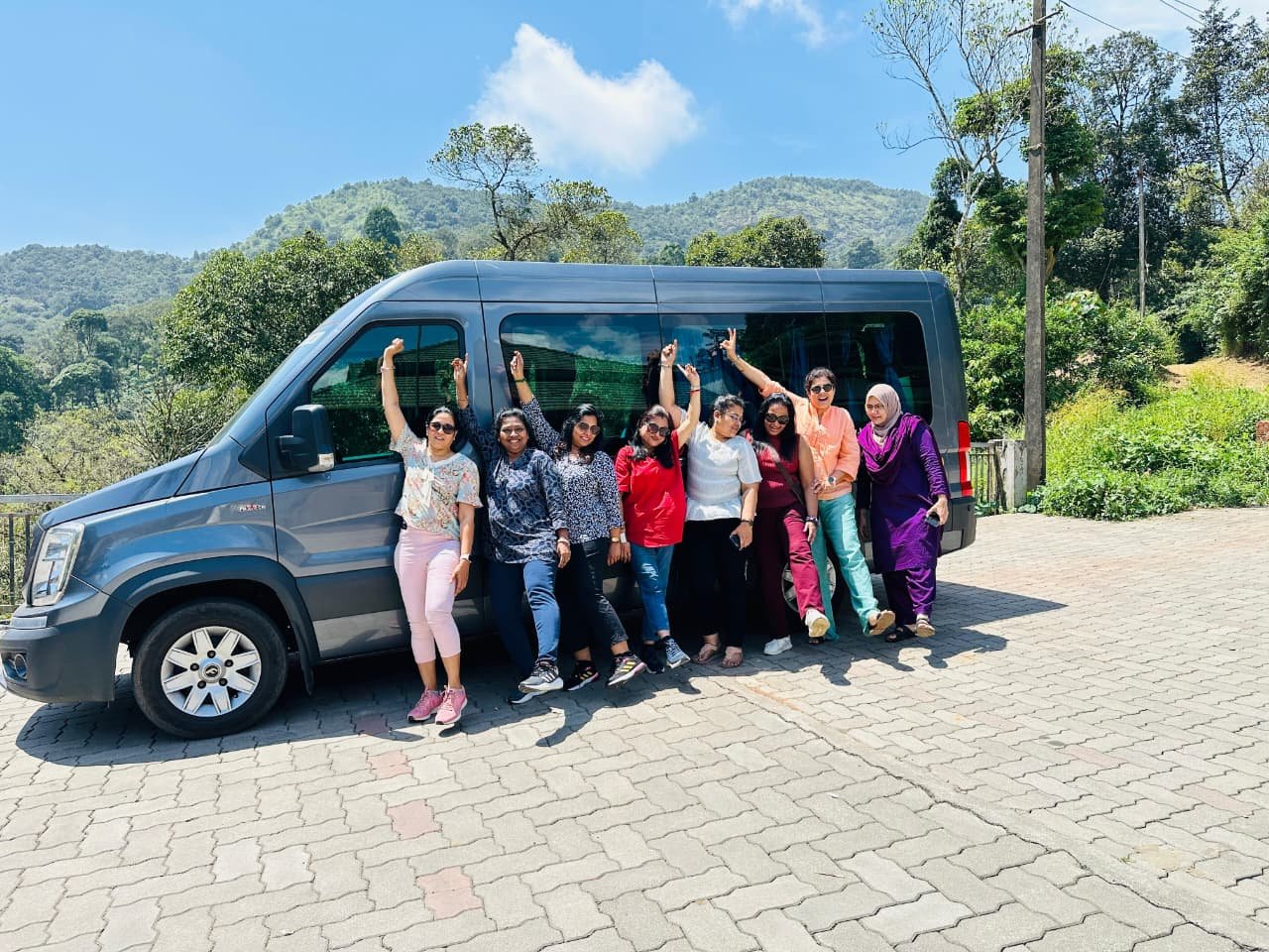 Force Urbania luxury van on a Munnar tea plantation road